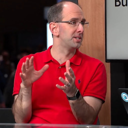 A picture of a middle-aged white man in a red shirt