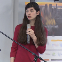 A picture of a young trans woman in a red dress